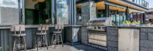 An outdoor kitchen just outside a home on a sunny day